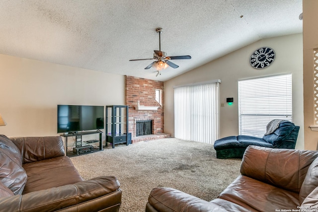 carpeted living room featuring vaulted ceiling, a healthy amount of sunlight, and a textured ceiling