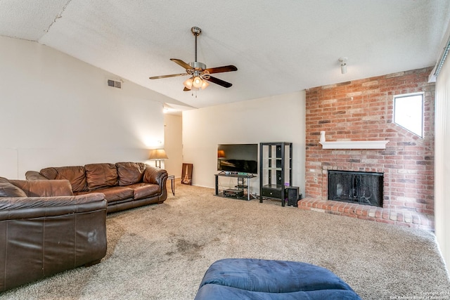 carpeted living room featuring vaulted ceiling, ceiling fan, a textured ceiling, and a fireplace