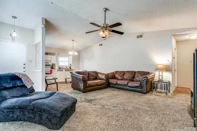 carpeted living room featuring ceiling fan with notable chandelier, vaulted ceiling, and a textured ceiling