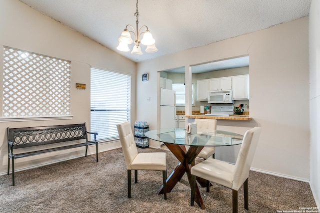 dining area featuring lofted ceiling, a textured ceiling, a chandelier, and carpet flooring