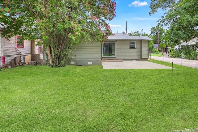 back of property featuring a yard and a patio