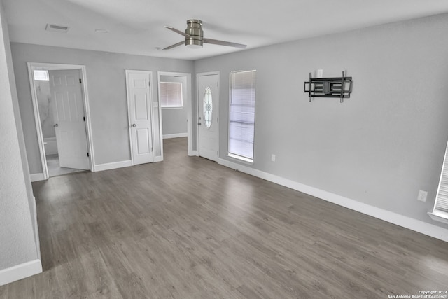 unfurnished living room featuring ceiling fan and hardwood / wood-style flooring