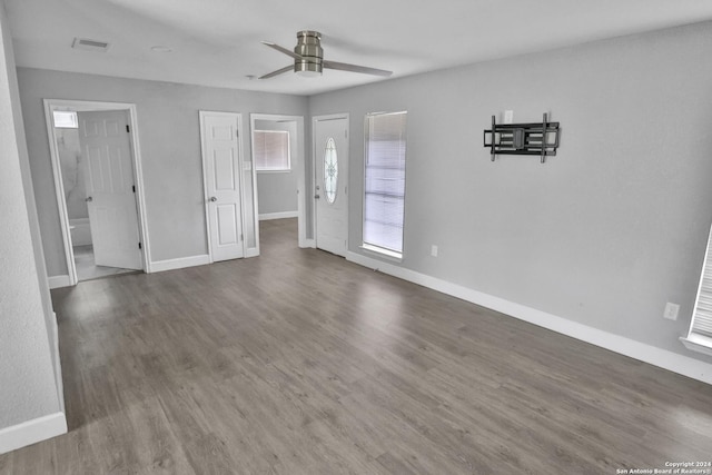 unfurnished room with dark hardwood / wood-style flooring and ceiling fan