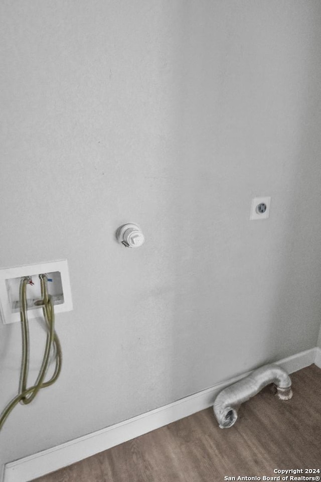 laundry area with hookup for a washing machine, wood-type flooring, and hookup for an electric dryer