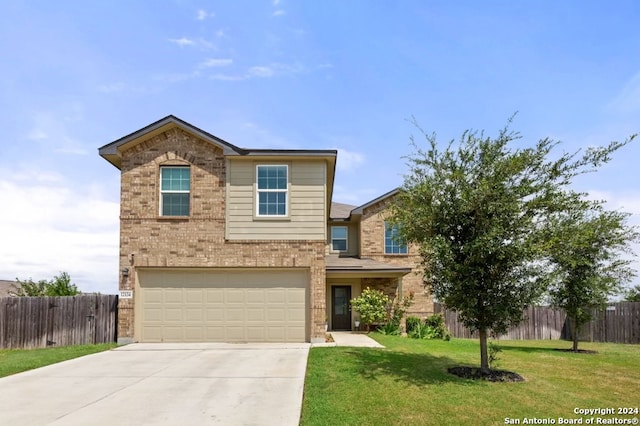 view of front of property with a garage and a front yard