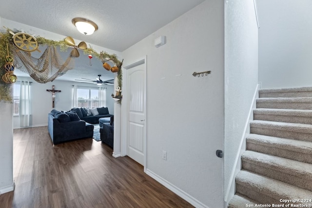 hallway featuring a textured ceiling and hardwood / wood-style flooring