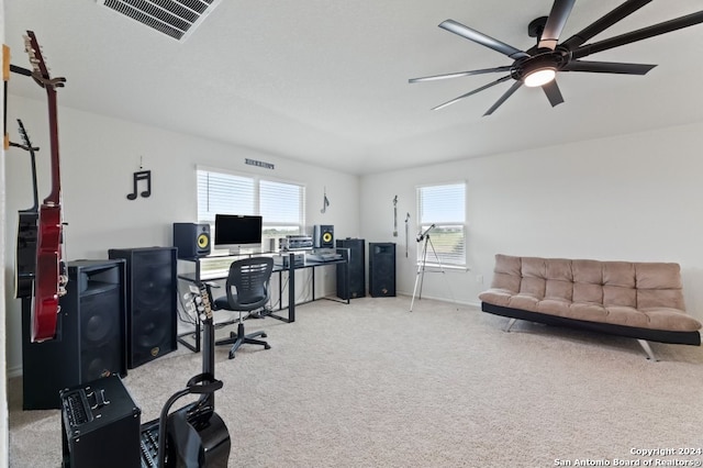 office space with plenty of natural light, ceiling fan, and light colored carpet