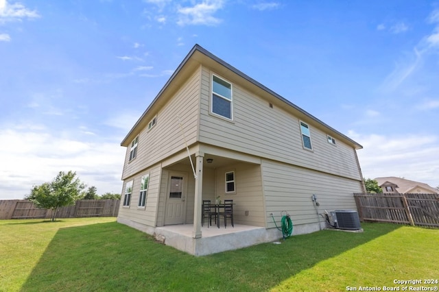 rear view of property with central AC, a lawn, and a patio area