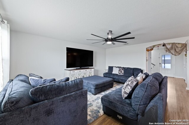 living room with hardwood / wood-style flooring and ceiling fan