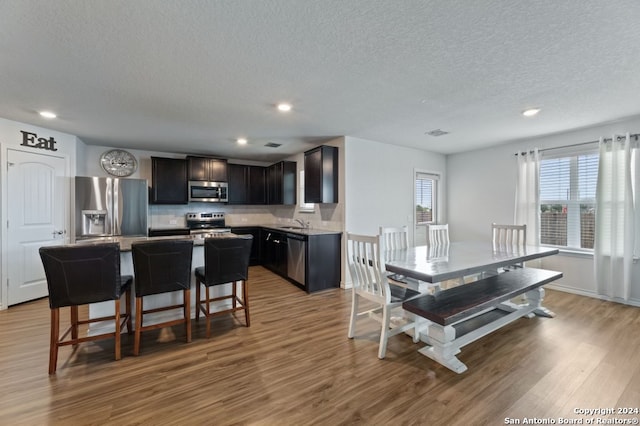 kitchen with plenty of natural light, a center island, appliances with stainless steel finishes, and light wood-type flooring