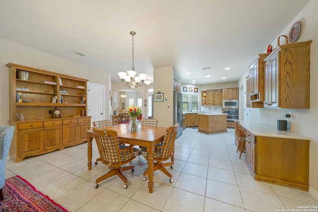 dining room featuring light tile patterned floors, visible vents, arched walkways, and recessed lighting