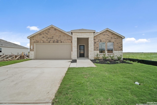 view of front of home with a garage and a front lawn