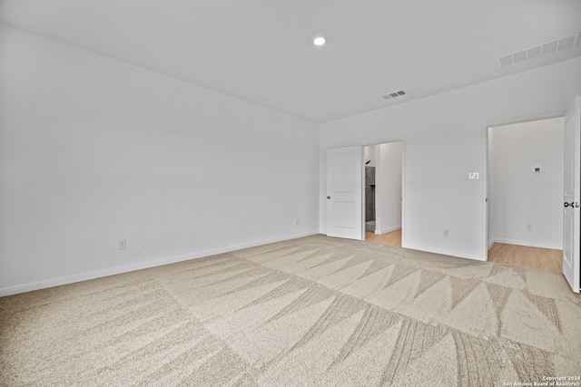 empty room featuring light colored carpet