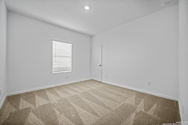 empty room featuring light colored carpet