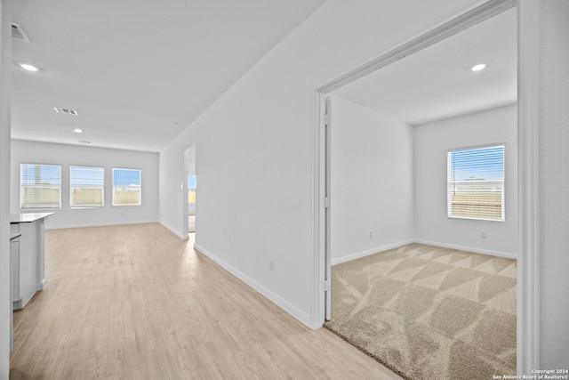 unfurnished room featuring light colored carpet