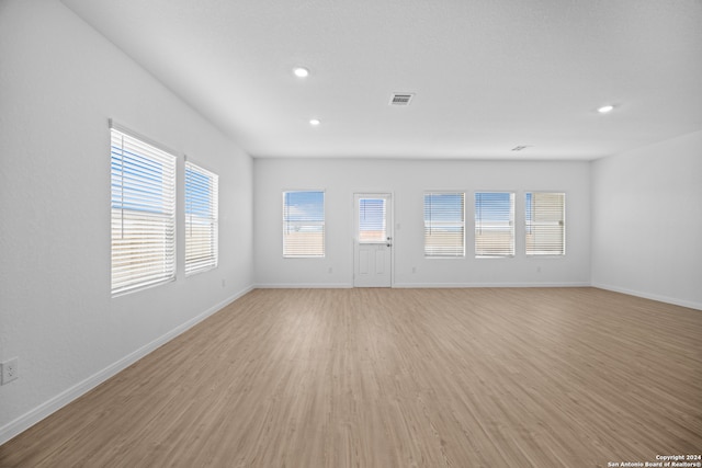 unfurnished room featuring light hardwood / wood-style flooring and a wealth of natural light