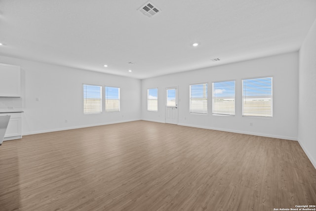 unfurnished living room featuring light hardwood / wood-style floors