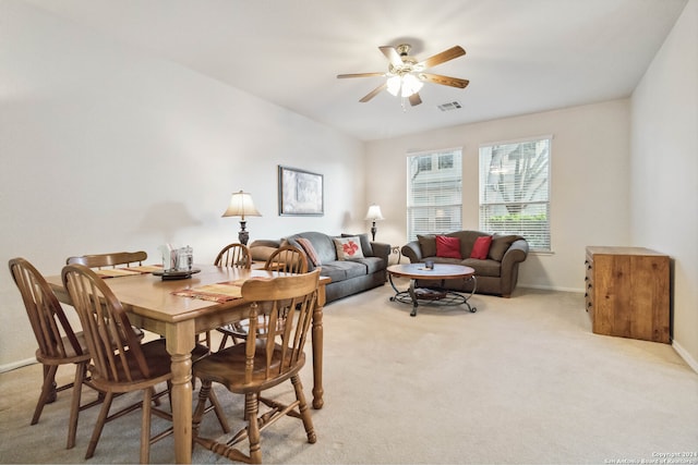 carpeted dining space featuring ceiling fan