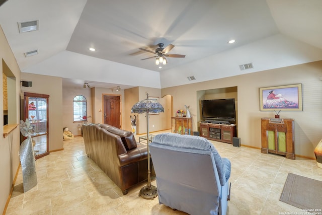 living room featuring ceiling fan and lofted ceiling