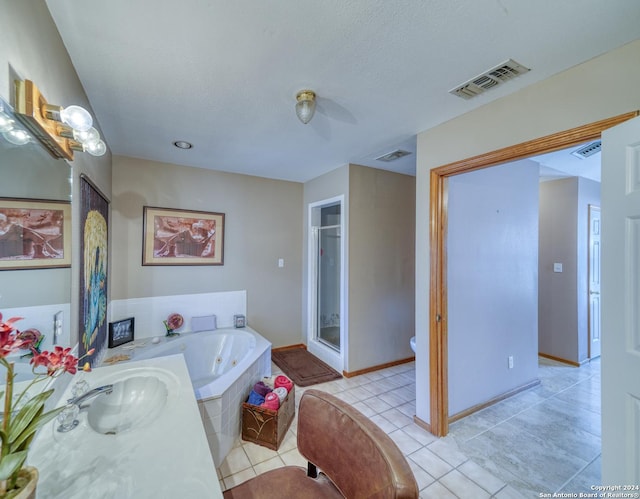 full bathroom with sink, separate shower and tub, a textured ceiling, tile patterned floors, and toilet