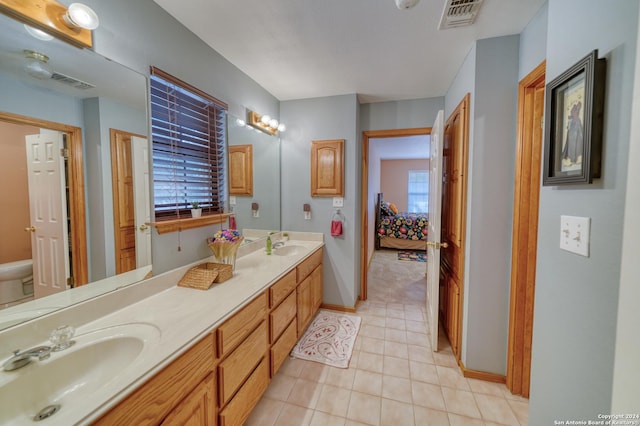 bathroom featuring tile patterned floors, vanity, and toilet