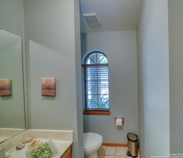 bathroom with vanity, tile patterned floors, and toilet