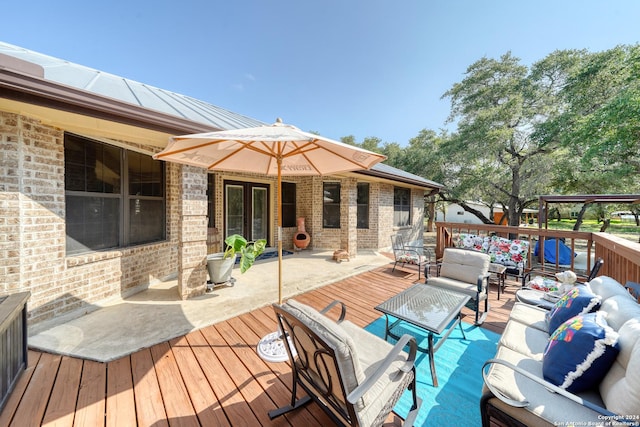 wooden terrace with an outdoor living space