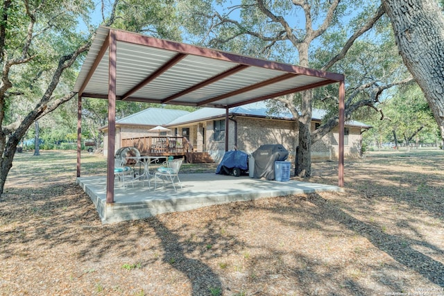 view of yard featuring a wooden deck and a patio area