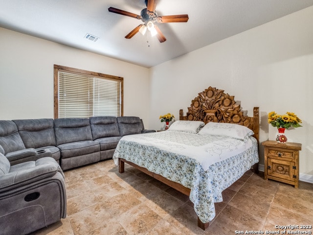 bedroom featuring tile patterned flooring and ceiling fan