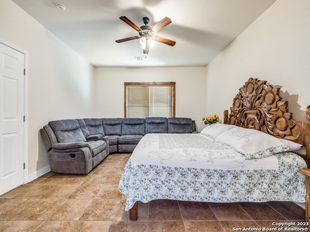 bedroom featuring light tile patterned flooring and ceiling fan