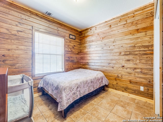 tiled bedroom with wood walls