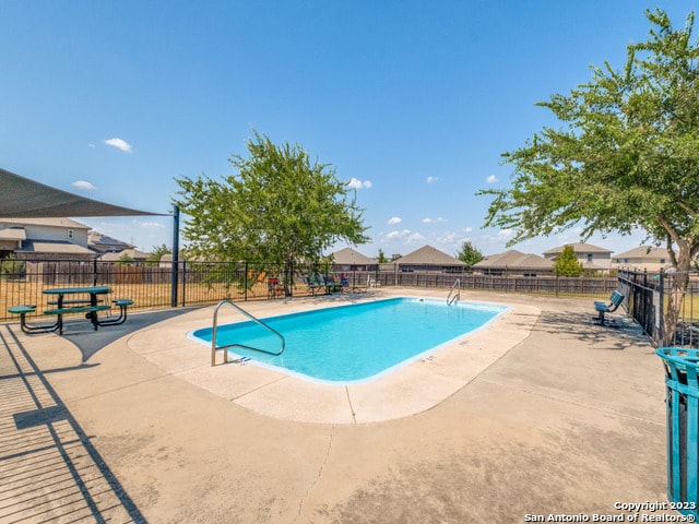 view of swimming pool featuring a patio area