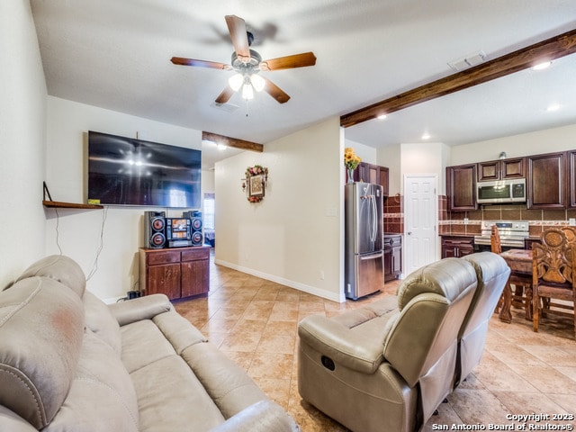 living room featuring light tile patterned floors, beam ceiling, and ceiling fan