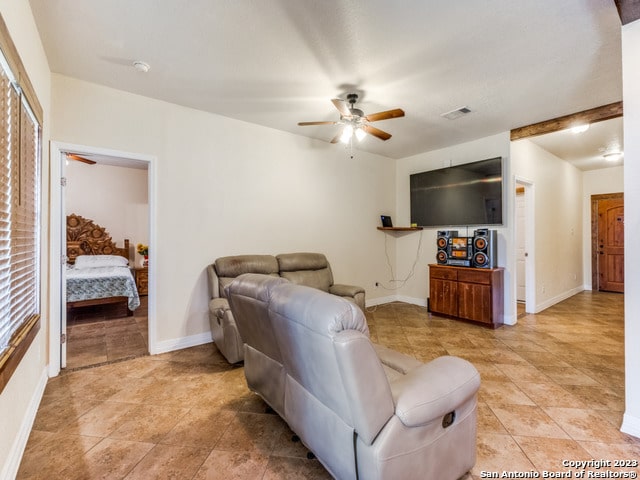 living room with light tile patterned flooring and ceiling fan