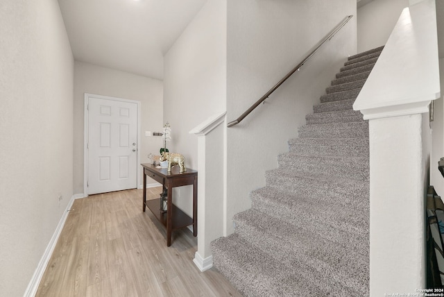 stairs with hardwood / wood-style flooring