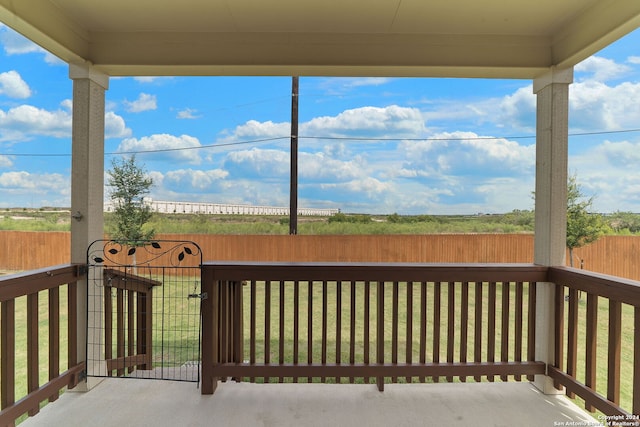 wooden deck featuring a lawn