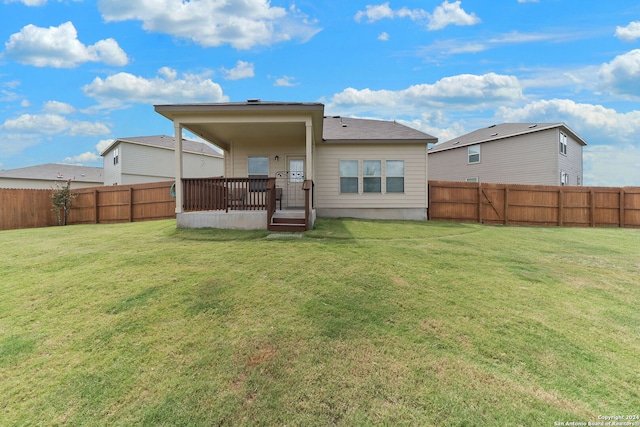 rear view of house with a lawn