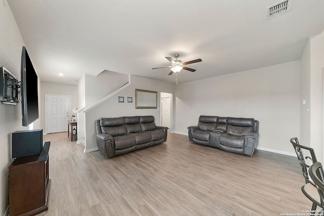 living room featuring ceiling fan and light wood-type flooring