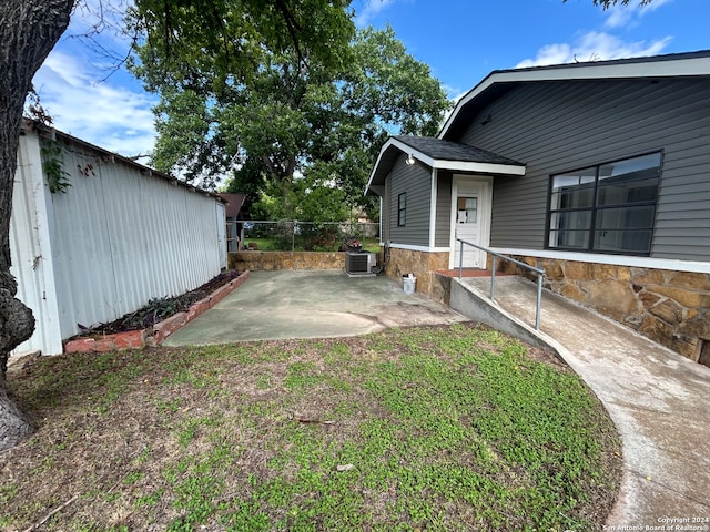 view of yard with a patio area and central AC