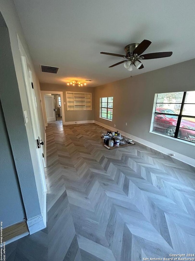 empty room featuring parquet flooring and ceiling fan