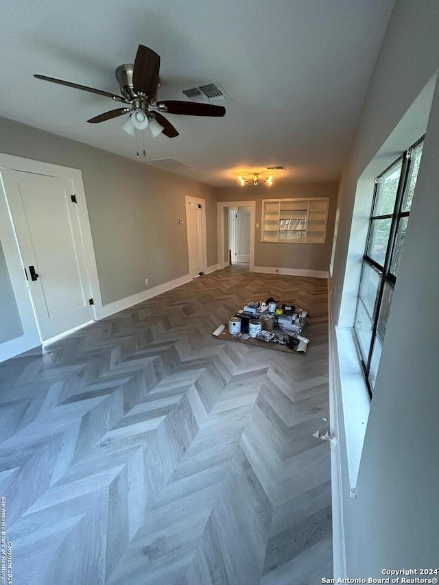 interior space with ceiling fan and parquet floors