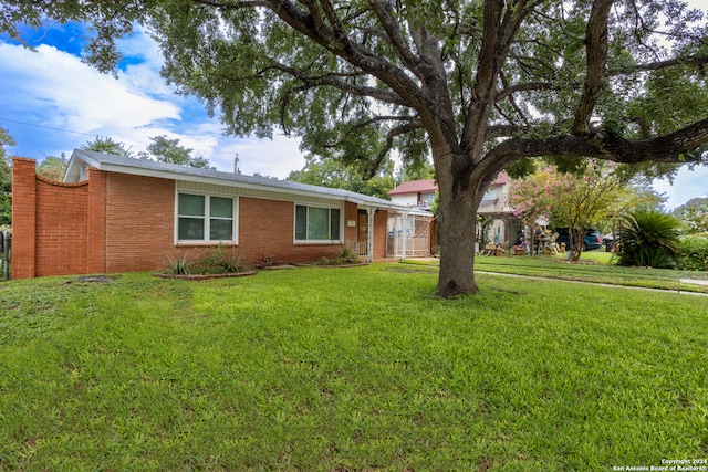 ranch-style house with a front lawn