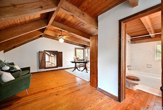 living room featuring light hardwood / wood-style flooring, vaulted ceiling with beams, a wealth of natural light, and wooden ceiling