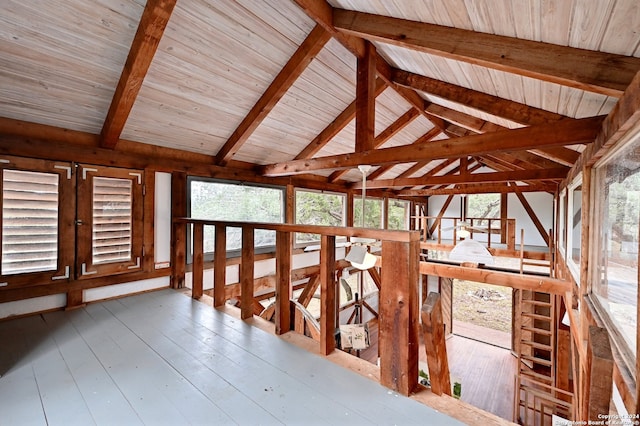 unfurnished sunroom featuring lofted ceiling with beams and wood ceiling