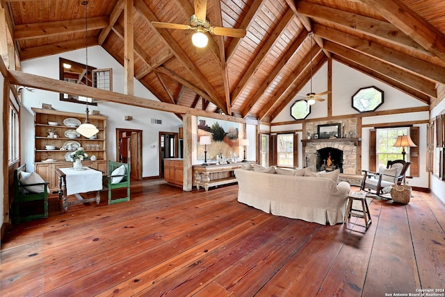 living room featuring wood ceiling, a fireplace, beam ceiling, and hardwood / wood-style flooring