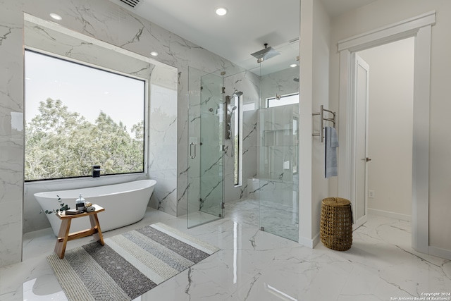 bathroom featuring shower with separate bathtub, tile patterned flooring, and tile walls