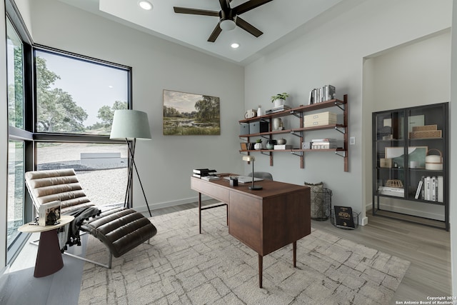 home office featuring light hardwood / wood-style floors and ceiling fan