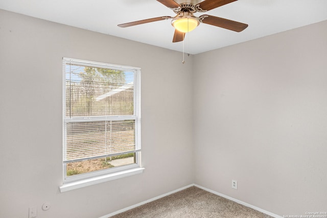 carpeted spare room with ceiling fan