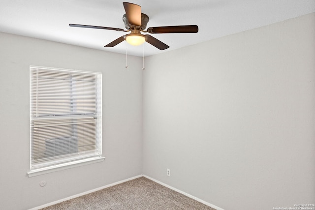 spare room with carpet floors and ceiling fan