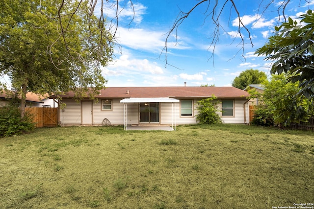 rear view of property with a patio area and a lawn